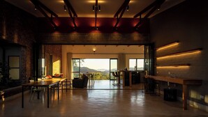 A spacious, modern kitchen with a large dining area, a bar, and a view of the mountains.