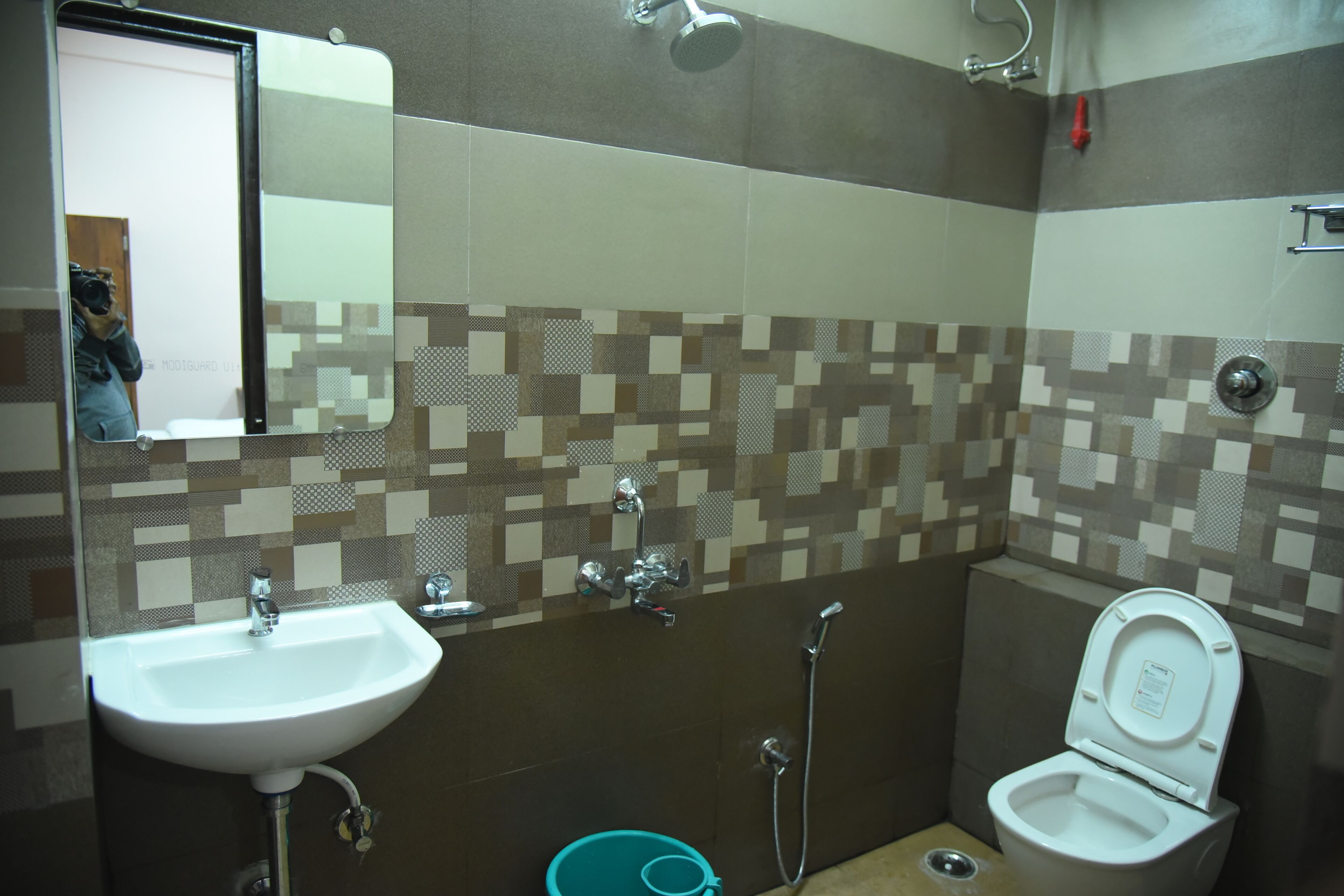 A bathroom with a sink, toilet, and shower.
