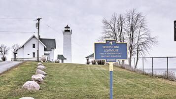 A lighthouse sign with historical information.