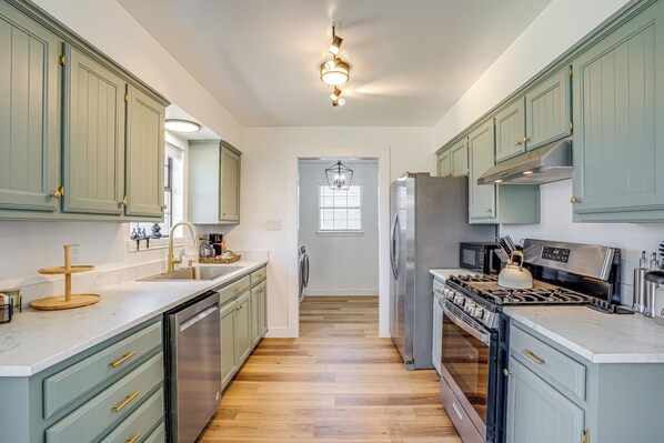 A kitchen with light green cabinets, a stainless steel refrigerator, a gas stove, and a dishwasher. - 7 Mi to Lake Bridgeport: Home w/ Yard & Grill! (Bridgeport)