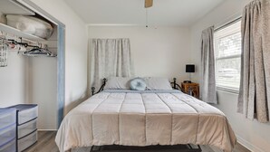A bedroom with a bed, a ceiling fan, a wardrobe, and a window with curtains. - Boat, Hike, & Golf: Inviting Inverness Getaway! (Inverness)