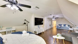 A bedroom with a bed, a desk, a TV, and a ceiling fan. - 4 Mi to Dtwn: Riverside Gem w/ Pool & Game Room (Riverside)