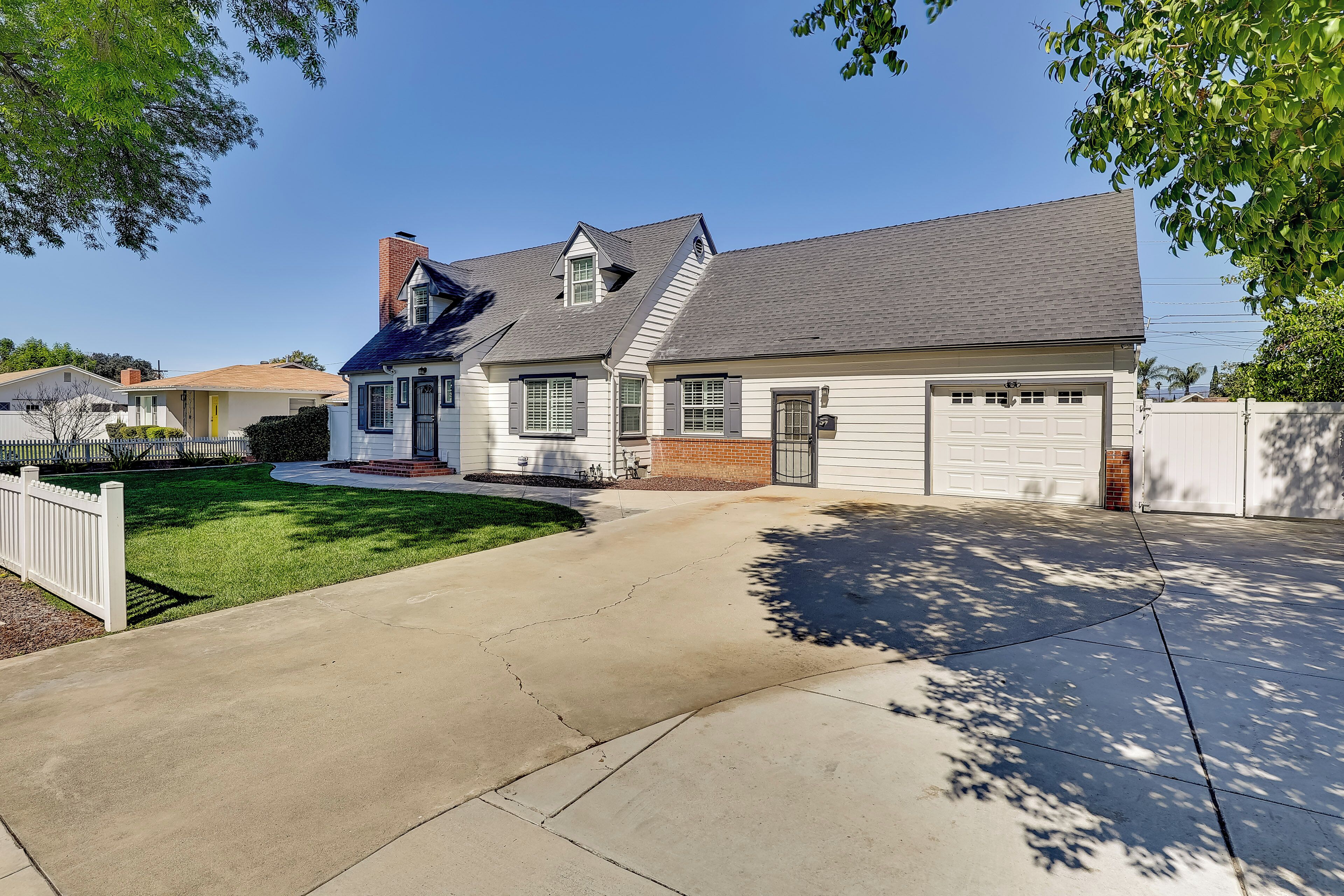 A residential house with a garage, a front lawn, and a driveway.