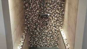 A narrow shower area with mosaic tile walls and a tiled floor. - Nice house in the center of Arès (Unknown)
