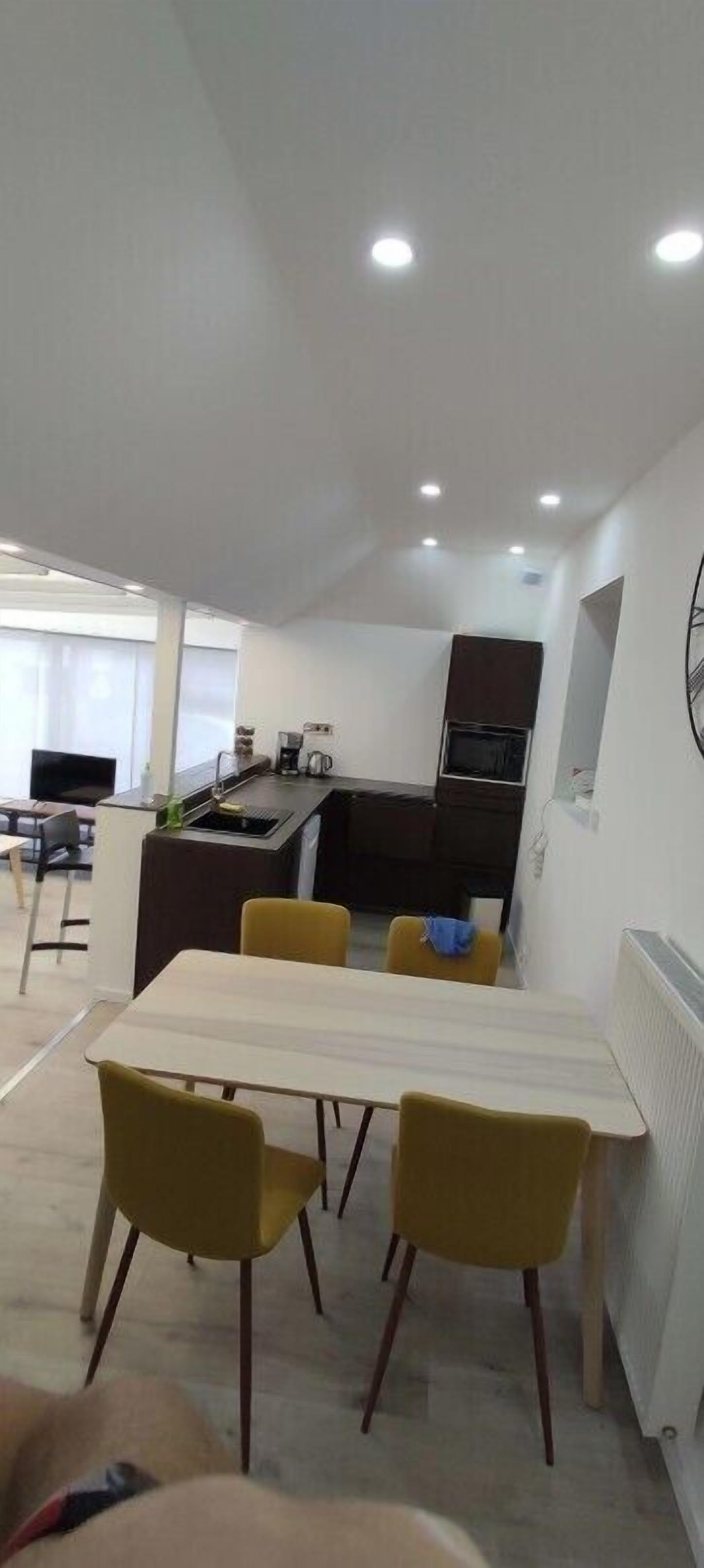 A modern kitchen with a dining area.