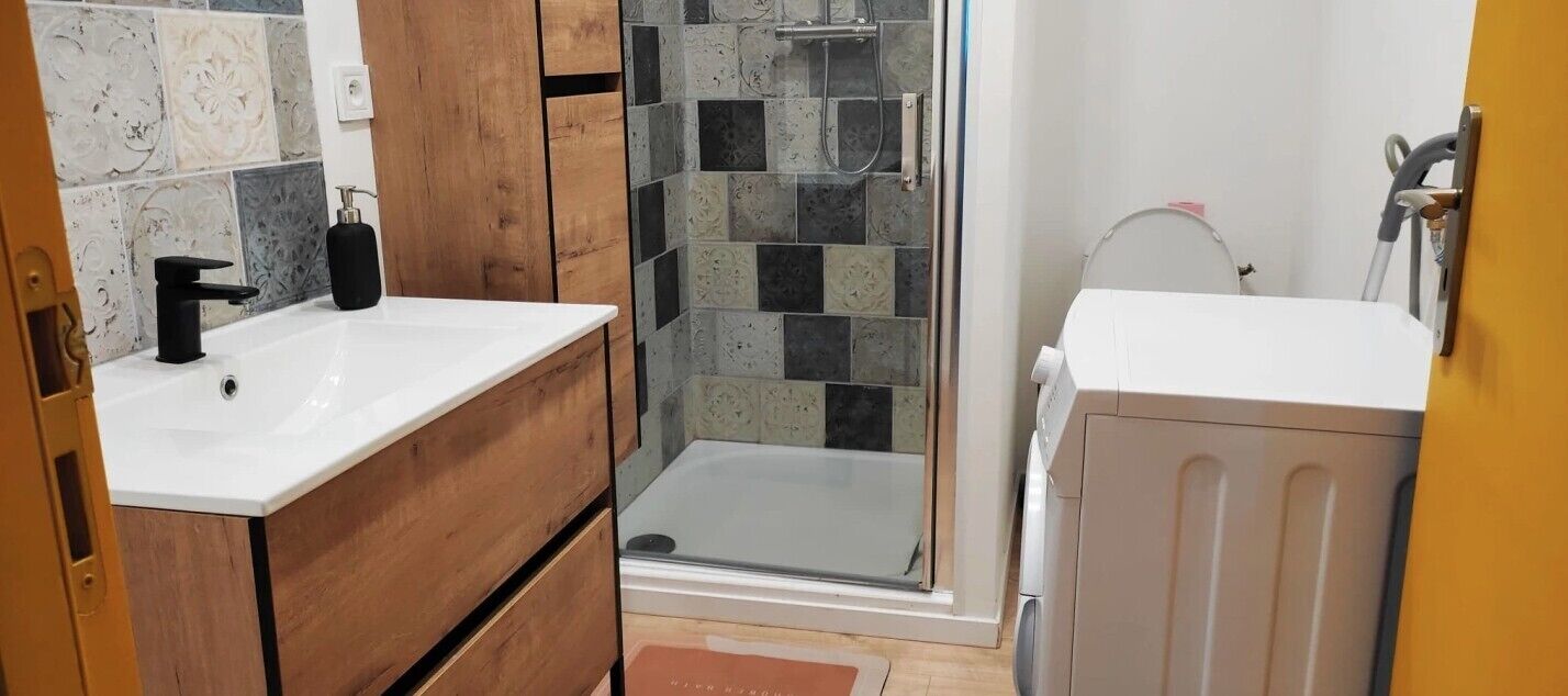 A bathroom with a shower, a sink, and a toilet.