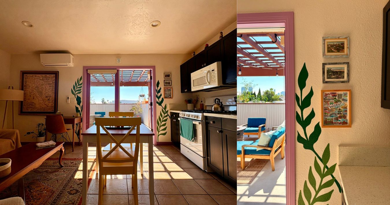 Uma cozinha com área de refeições, janela com vista e parede decorada com quadros.