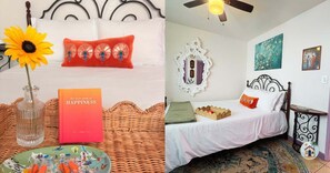 A room with a bed, a decorative mirror, and a ceiling fan.