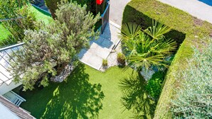 A well-maintained garden with various plants and a neatly trimmed hedge.