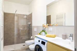 Shower, hair dryer, towels, toilet paper