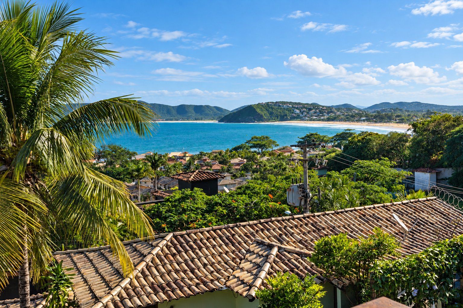 A coastal town with traditional architecture, a beach, and a mountainous backdrop.