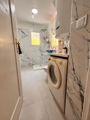 Shower, hair dryer, towels, toilet paper