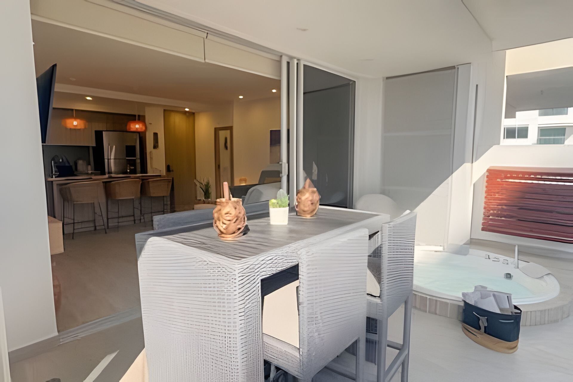 A modern interior with a dining area, kitchen, and a view of the outside.