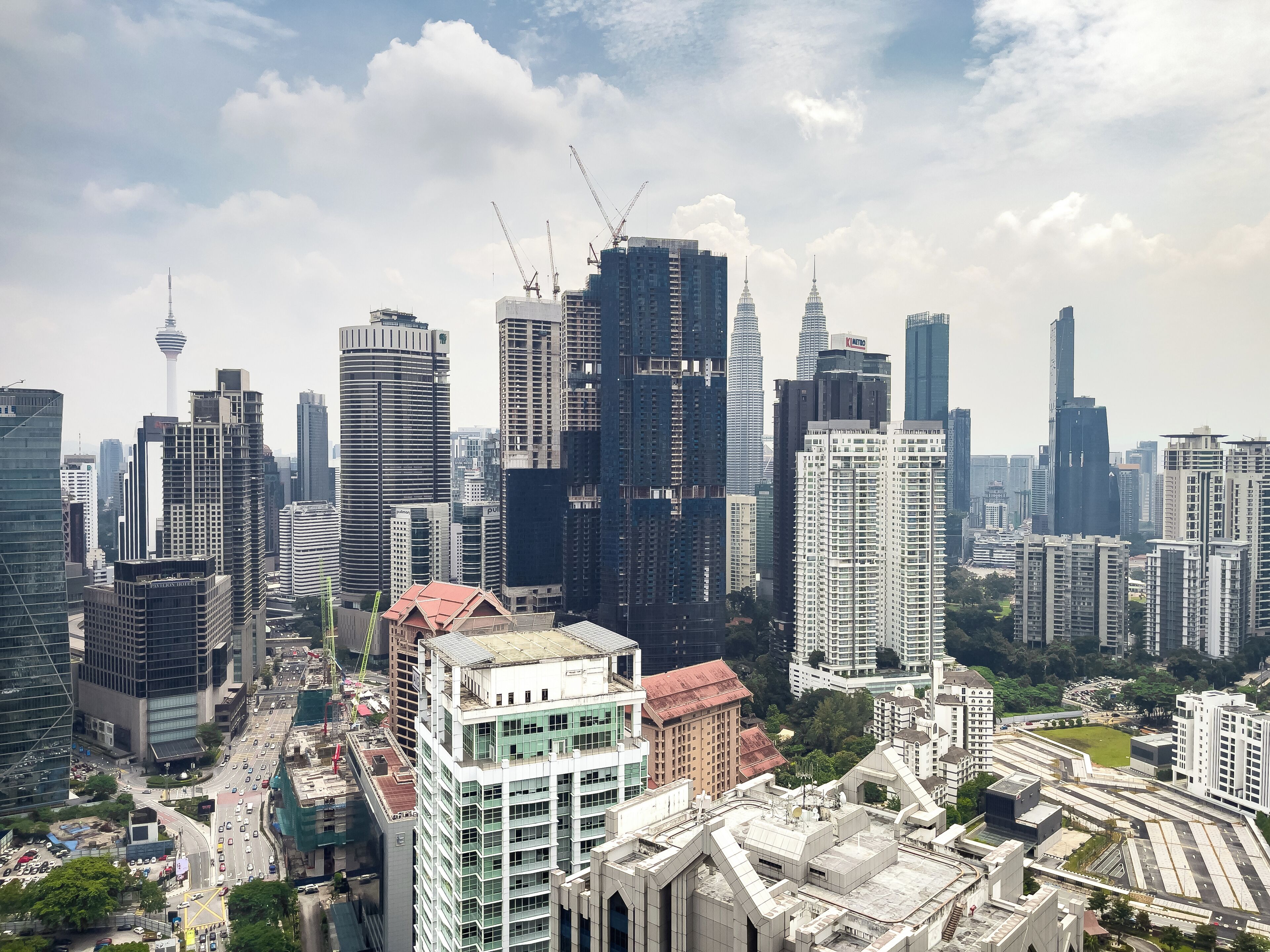 A cityscape with high-rise buildings, a prominent tower, and a mix of modern and older architecture.