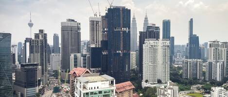 A cityscape with high-rise buildings, a prominent tower, and a mix of modern and older architecture.