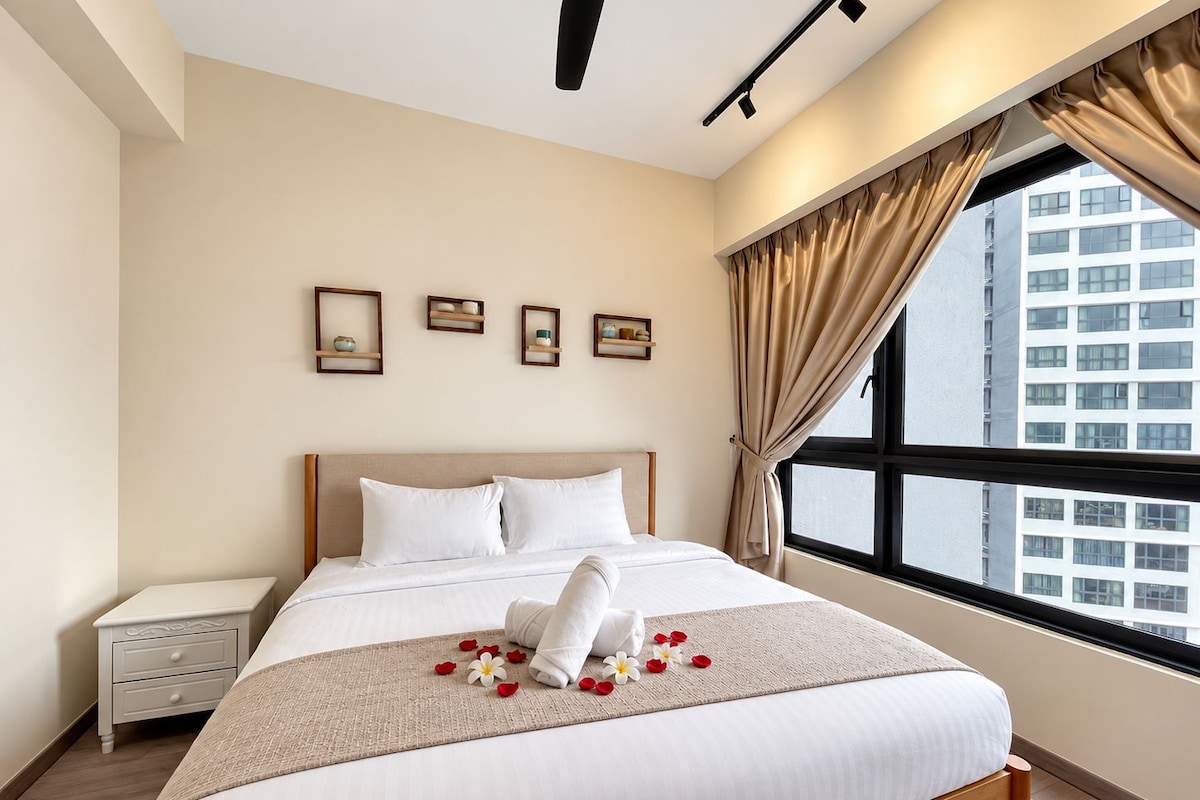 A hotel room with a large bed, a nightstand, a window with curtains, and wall-mounted shelves with decorative items.