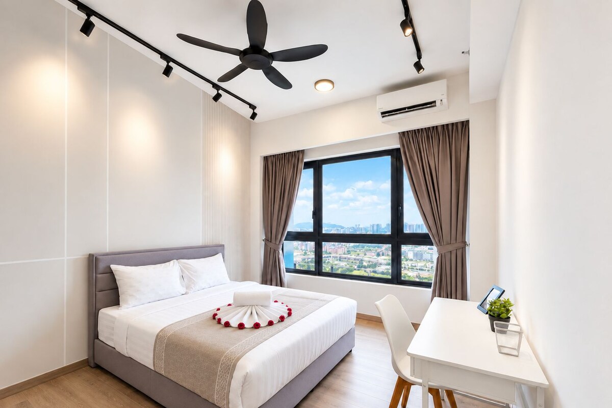 A modern hotel room with a bed, a desk, a chair, a ceiling fan, and a large window with a city view.