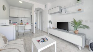 A modern apartment with a kitchen, dining area, and living room. - Eva Vacation Home Pool & Relax - Very close to the beach (Puerto del Carmen)