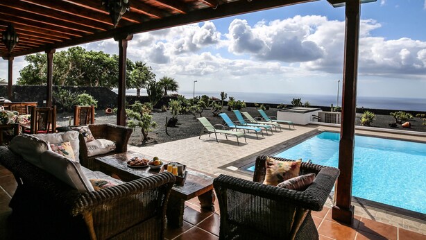 A covered outdoor area with wicker furniture, a pool, and a view of the ocean. - Horizon Luxury -A peaceful oasis with private pool (Macher)
