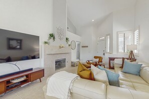 TV, fireplace, books - Sun, Comfort, and Stunning Views, Shared pool & Dog-friendly (Palm Desert)