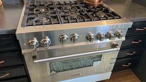 A stainless steel stove with a built-in oven, multiple burners, and a control panel.