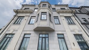 A multi-story building with a symmetrical facade, large windows, and a central entrance.