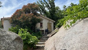 A rustic stone house with a wooden sign reading "AFIGA" in front. - "A Figa" Authentic stay in U Sirenu (SARTENE)