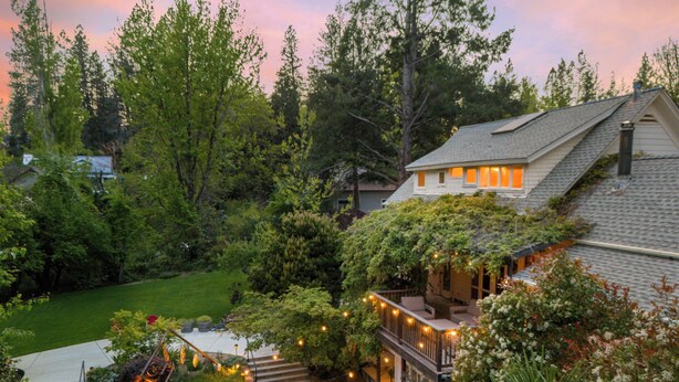 A house with a covered porch, a stone pathway, and outdoor seating. - Dreamy 5-bedroom Estate in Beautiful Downtown Nevada City with Pool (Nevada City)