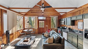 A spacious kitchen with modern appliances, a dining area with a table and chairs, and a cozy seating area with a sofa. - Dreamy 5-bedroom Estate in Beautiful Downtown Nevada City with Pool (Nevada City)