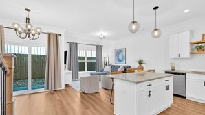 A modern kitchen with white cabinetry, a central island, and pendant lighting. - Gated Community~Brand new townhouse~Downtown Rome (Rome)