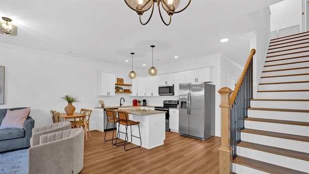 A modern kitchen with white cabinets, a central island, and stainless steel appliances. - Gated Community~Brand new townhouse~Downtown Rome (Rome)