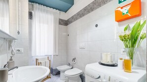 A modern bathroom with a sink, toilet, bidet, and washing machine. - Apartment Vaticana - Two Bedroom Villa, Sleeps 6 (Rome)