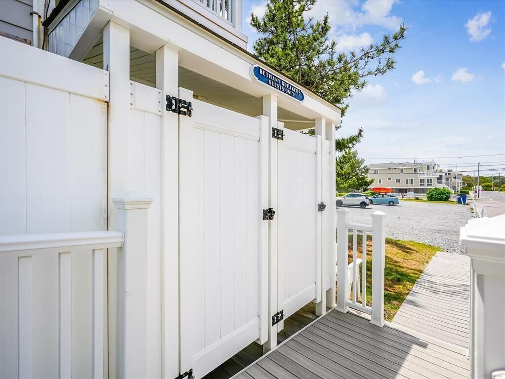 A white building with a sign reading "Bethany Beach Guest House."