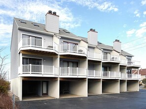 A multi-story residential building with balconies and a garage entrance.