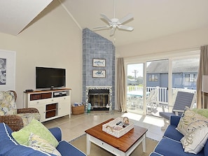 A living room with a television, fireplace, and seating area. - Stylish 4BR by Bethany Beach Boardwalk | Sleeps 10 (Bethany Beach)