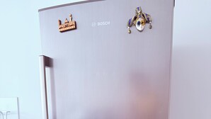 A stainless steel Bosch refrigerator with a freezer compartment on the top and a freezer compartment on the bottom.