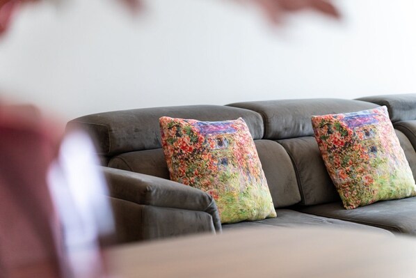 A sectional sofa with floral-patterned cushions.