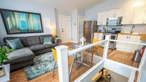 A modern apartment with a living room, kitchen, and balcony. - Historic 1BR DT in amazing location steps from waterfront in Old South District (Halifax)