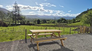 A picnic table in a rural setting with a mountain view. - Swallow's Nest (Keswick)