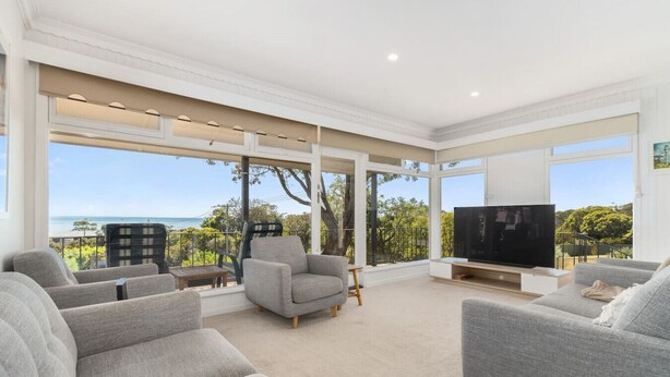 A modern living room with large windows, a flat-screen TV, and grey sofas. - Kookaburras Perch - McCrae (McCrae)