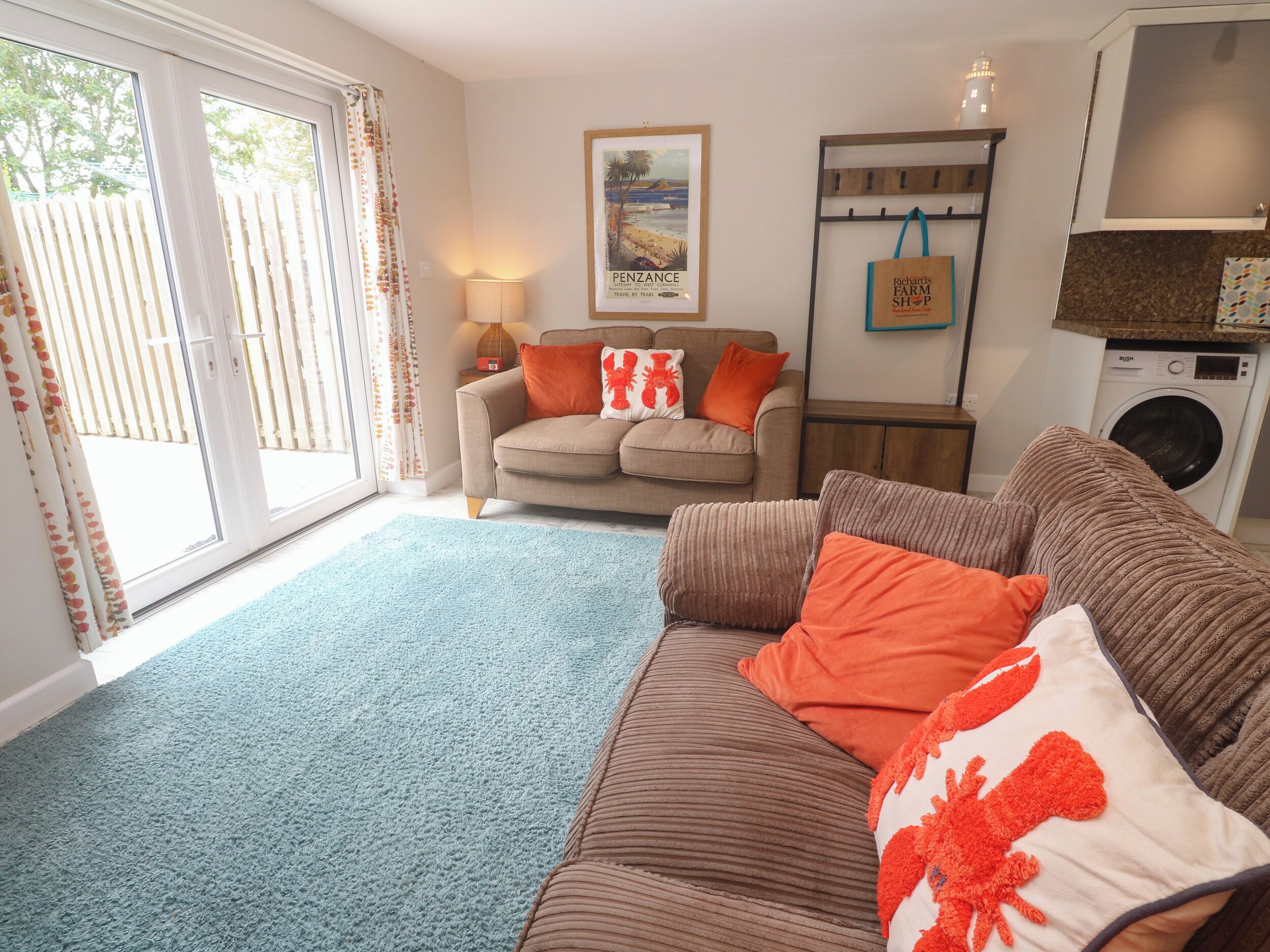 A living room with a sofa, a coffee table, a lamp, and a framed picture on the wall.