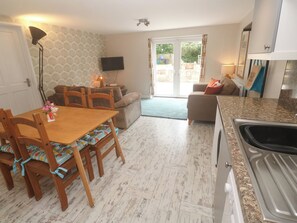 A compact living space with a dining area, kitchen, and seating area.
