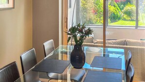 A conference room with a glass table, black chairs, and a vase with flowers. - 3 bedroom accommodation in Monyash, near Bakewell (Monyash, near Bakewell)
