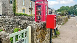 A traditional stone cottage with a red telephone booth labeled 'BOOKS' and 'MONVASH' in front. - 3 bedroom accommodation in Monyash, near Bakewell (Monyash, near Bakewell)