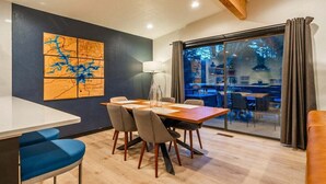 Een eetgedeelte met een tafel, stoelen en een kaart aan de muur.