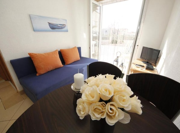 Apartment (One Bedroom Apartment 7) | Living room | 32-inch flat-screen TV with cable channels