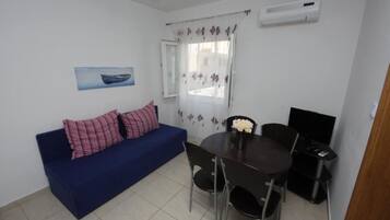Apartment (One Bedroom Apartment 6) | Living room | 32-inch flat-screen TV with cable channels