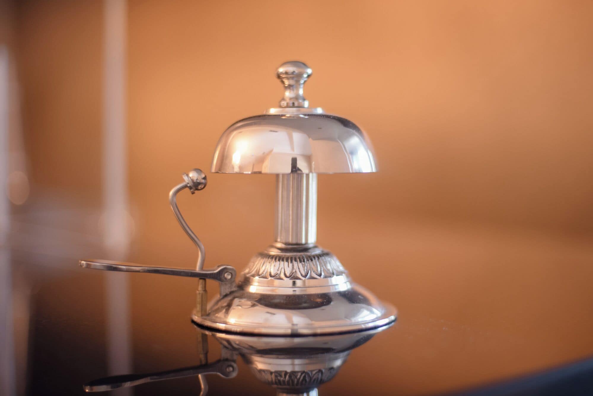 A metallic object with a dome-shaped top and a handle, likely a piece of furniture or equipment.