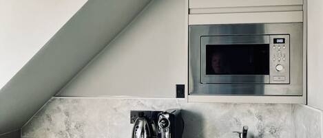 Microwave, stovetop, coffee/tea maker, cookware/dishes/utensils