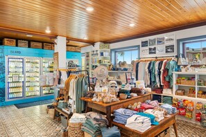 A store with local crafts, clothing racks, and a display of hats. - Coastal Caviar - Beluga Suite - with Rooftop Deck (Charleston)